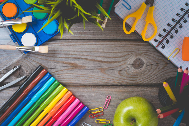 School supplies on wooden table with empty notebook. - Photo, Image