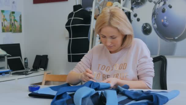 Professional tailor, designer measuring suit jacket for sewing at atelier - Filmagem, Vídeo