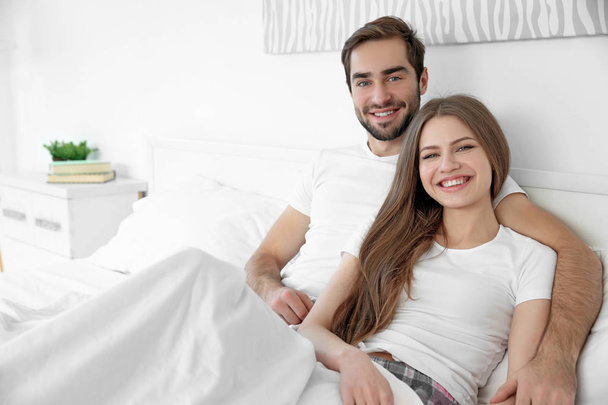 Young cute couple in bed - Φωτογραφία, εικόνα