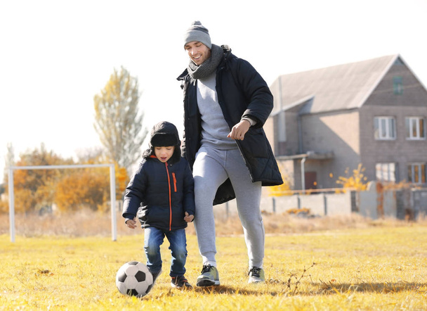 Father and son playing football - Foto, imagen