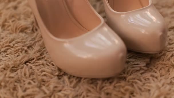 Close up view of womans nude highheels on the carpet. Bridal wedding shoes. - Footage, Video