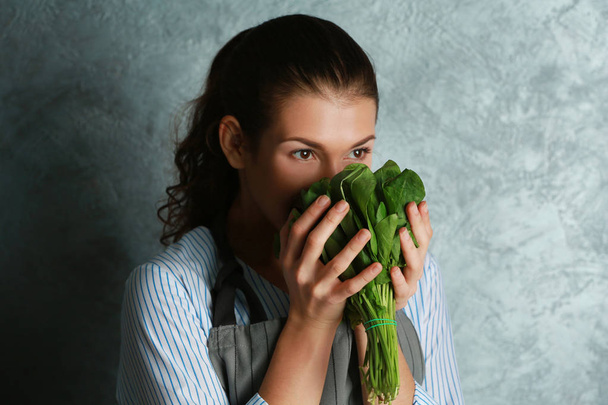 Woman smelling fresh herbs  - Foto, afbeelding