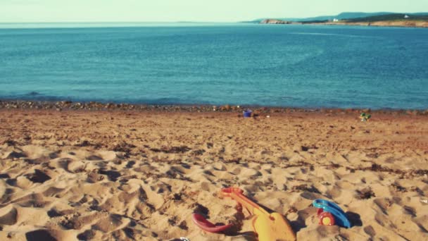Beach toys lying in the sand  - Materiał filmowy, wideo