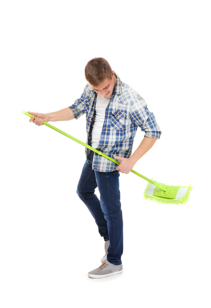 Young service man holding mop on white background - Fotografie, Obrázek