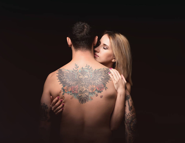 woman hugging tattooed man - Photo, image