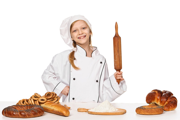Little girl baker on kitchen with rolling pin - Photo, Image