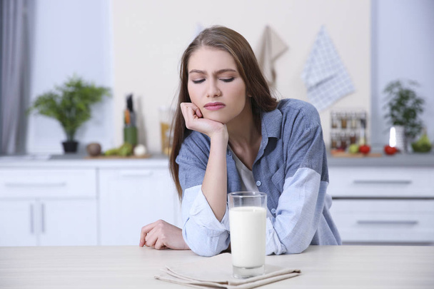 Young woman refusing to drink milk - Фото, зображення