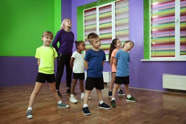Dance teacher and children in choreography class - Photo, Image
