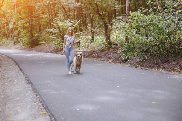 couple walking outdoors with her dog - Zdjęcie, obraz