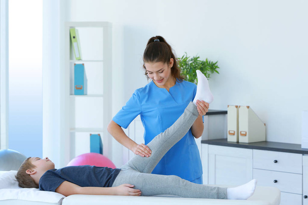 Physiotherapist working with patient in clinic - Photo, image