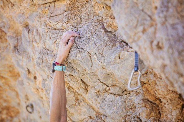 Closeup of climber's hand on cliff - Photo, Image