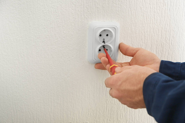 Electrician installing wall socket  - Φωτογραφία, εικόνα