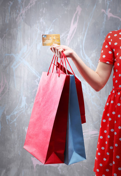 Woman with shopping bags and credit card - 写真・画像