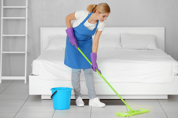 Pretty woman moping floor  - Фото, изображение