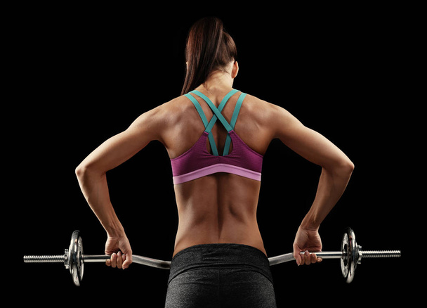 Sporty young woman with barbell  - Photo, Image