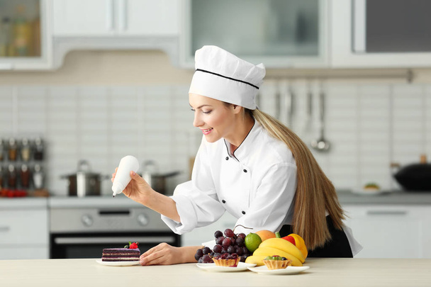 Female chef decorating cake  - Zdjęcie, obraz