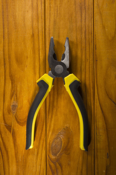 multitool pliers on wooden background - Фото, изображение