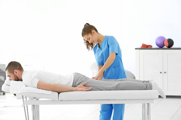 Physiotherapist working with patient  - Fotó, kép