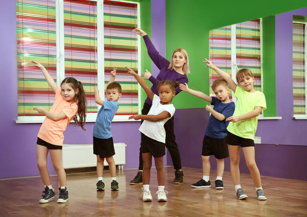 Dance teacher and children in choreography class - Photo, image