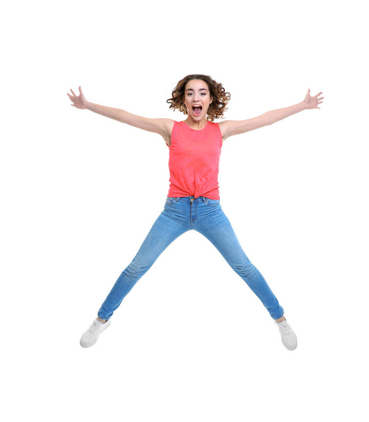 Joyful young woman jumping   - Valokuva, kuva