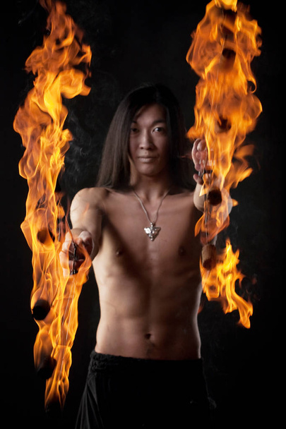asian man with fire show - Фото, изображение
