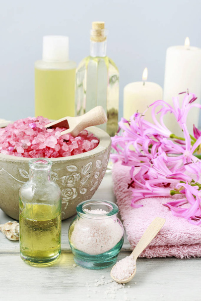 Bowl of sea salt and other spa cosmetics - Фото, зображення