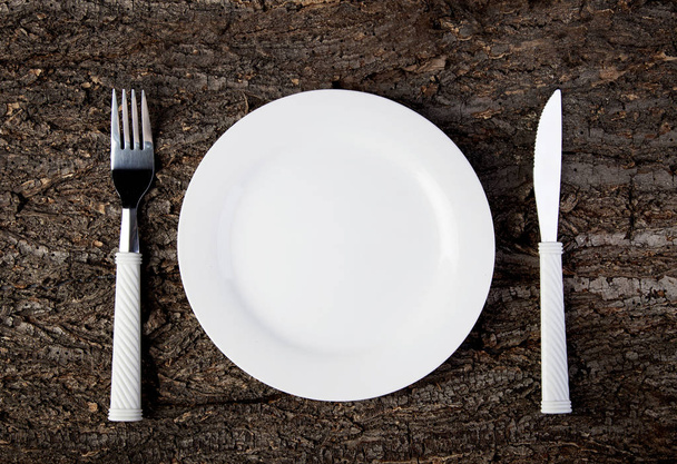 Plate fork knife empty wooden table - Foto, imagen