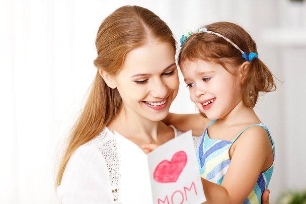 Happy mother's day! Child daughter congratulates moms and gives  - Zdjęcie, obraz