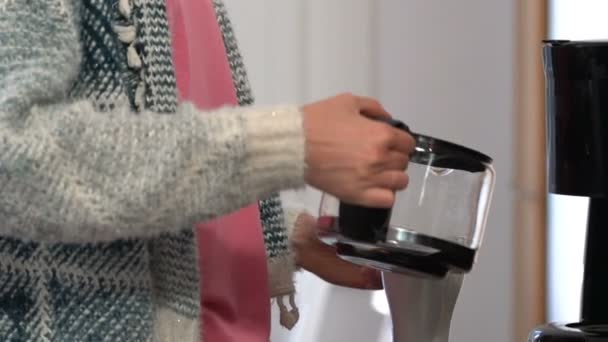 Happy woman drinking coffee in the kitchen and smiling at camera. Slow Motion. - Filmati, video