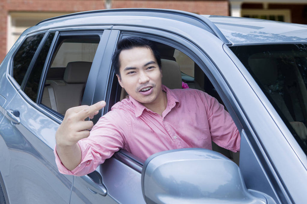 Angry driver shows middle finger - 写真・画像