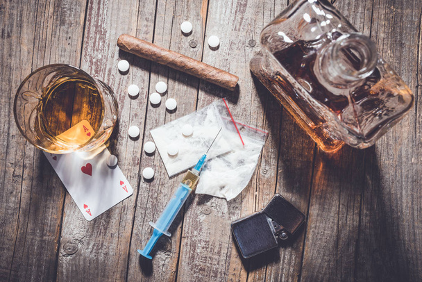 Hard drugs and alcohol on an old wooden table - Φωτογραφία, εικόνα