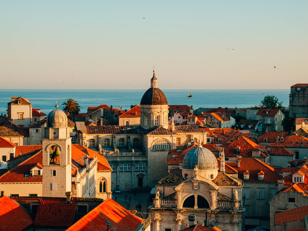 Dubrovnik Old Town, Croatia. Tiled roofs of houses. Church in th - Photo, image