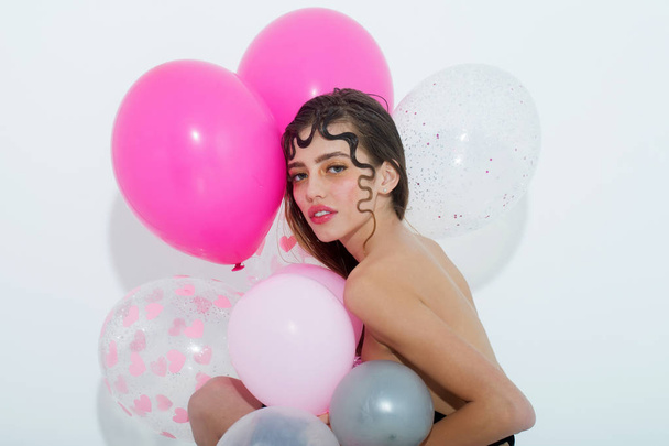 Pretty girl with pink party balloons isolated on white - Fotó, kép