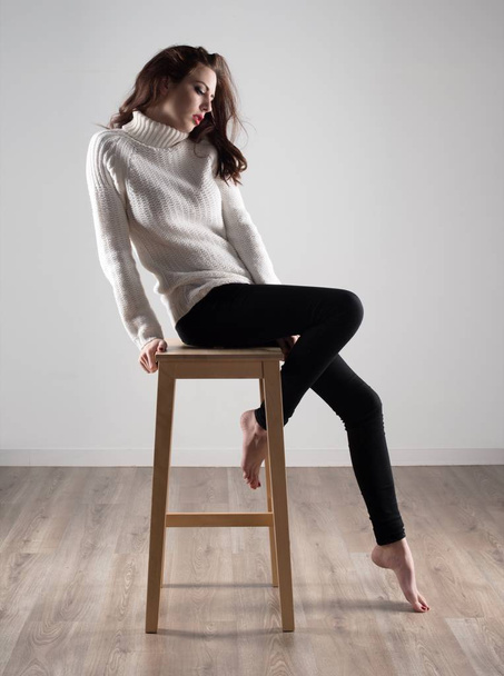 Kaunis malli nainen istuu puinen tuoli
 - Valokuva, kuva