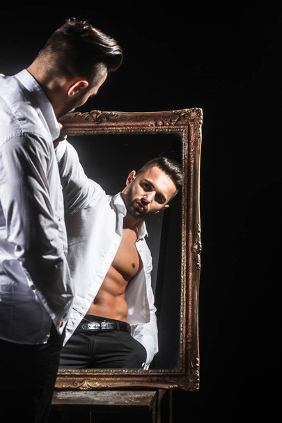 muscular macho man with sexy athlete body near vintage mirror - Foto, Imagem