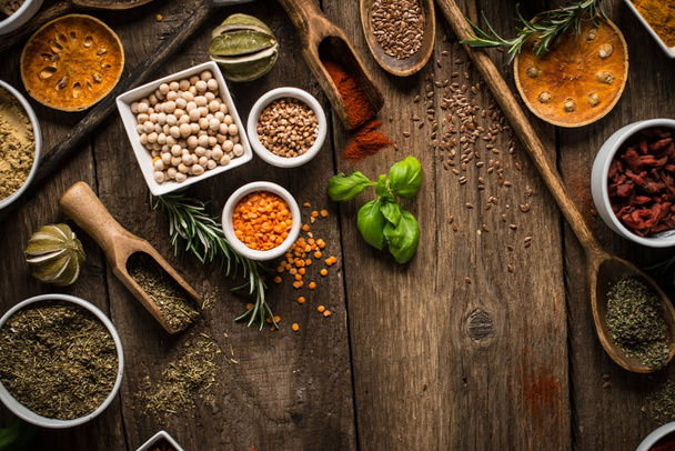 Various colorful spices on wooden table. Place for typography and logo - Photo, Image