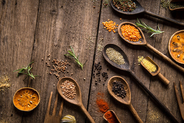 Various colorful spices on wooden table. Place for typography and logo - Fotoğraf, Görsel
