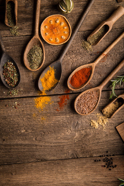 Various colorful spices on wooden table. Place for typography and logo - Photo, Image