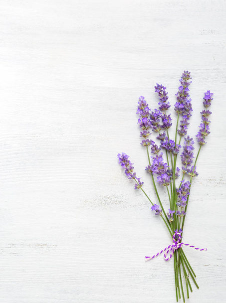 Few sprigs of lavender on  wooden background. - Foto, imagen