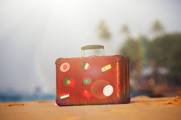 Travel  vintage suitcase is alone on a beach - Фото, изображение