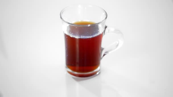transparent glass Cup with tea isolated on white. - Záběry, video