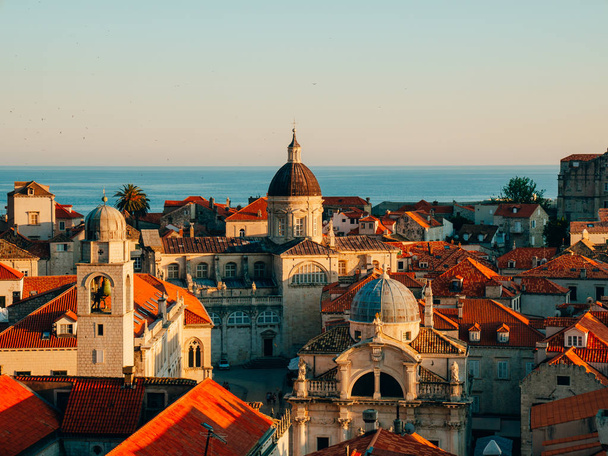 Dubrovnik Old Town, Croatia. Tiled roofs of houses. Church in th - Photo, image