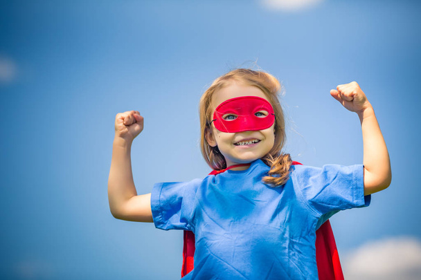 Funny little girl playing power super hero. - Foto, Imagen