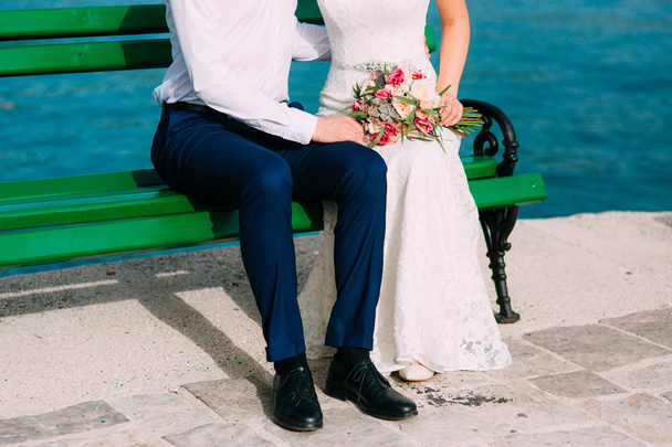 Newlyweds on the bench. Legs close-up - Photo, Image