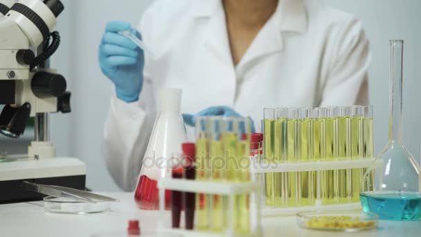 Mixed race research analyst working in laboratory, biochemical reaction - Filmmaterial, Video