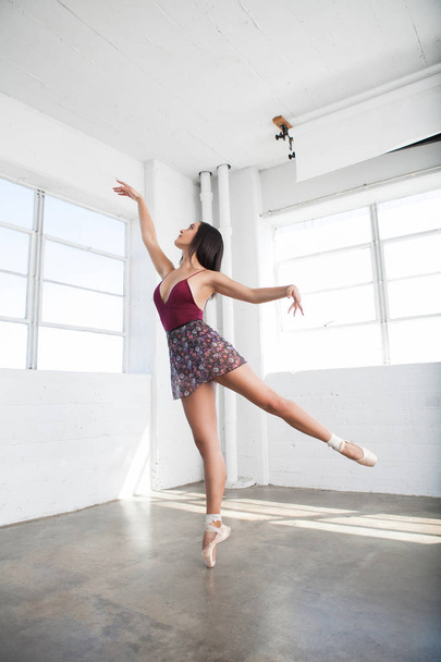 Beautiful young woman dancing in studio - Fotó, kép