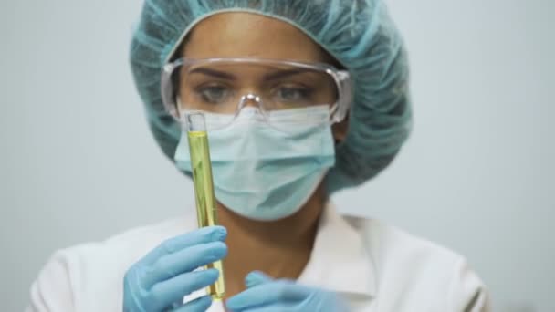 Beautiful lab assistant analyzing biomaterial in tubes, biochemical research - Footage, Video