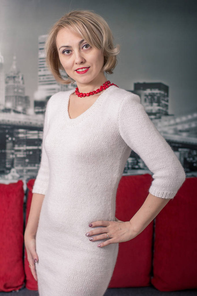 The beautiful girl in a beautiful knitted dress. Style and fashion.  - Valokuva, kuva