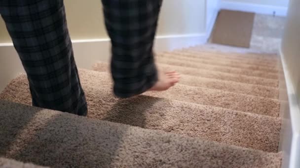 Mężczyzna idzie w dół po schodach i używa poręcz - Materiał filmowy, wideo