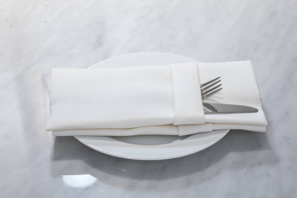Table appointments- fork,knife,spoon, silk napkin on bamboo mat  - Φωτογραφία, εικόνα
